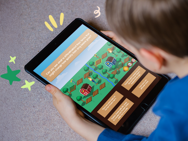 A child is holding a tablet with an educational app displaying colorful graphics and text designed for preschool education. Time4Learning pre-k